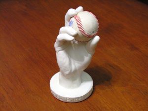 Custom-made 3D plaster cast of hand holding a baseball.