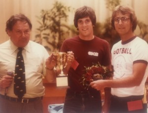 Ellis Mendelsohn hands over the Turtle Derby trophy to two participants, including John Smith (right), now assistant director of intramurals at UofL.