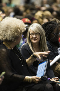 Cate Fosl, director of the Anne Braden Institute, speaks to activist Angela Davis.  