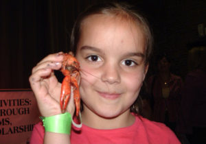 Hannah Kemper attending her first Crawfish Boil in the Red Barn when she was 8 years old. She is now a sophomore at UofL and one of the event's organizers this year.