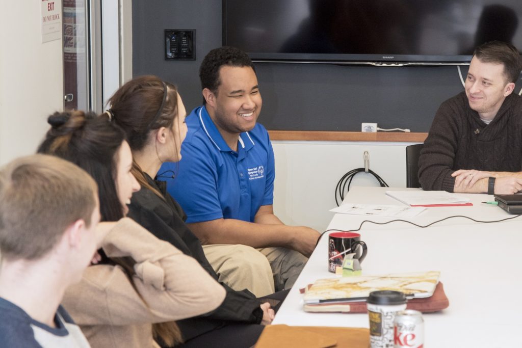 Special Olympics Kentucky Athlete Ambassador Morgan Turner (in blue) talks with second-year medical students at the University of Louisville