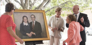 Heddy Kurz unveils a portrait of her and her late husband, Herman Kurz, that will be hung in UofL's new welcome center that bears their name.