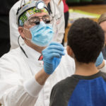 A child receives dental care from UofL.