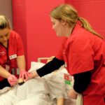 UofL School of Nursing students Abigail Babbitt, left, and Courtney Albers practice administering medications on a patient simulation mannequin in the lab that will be renovated courtesy of $250,000 in donations from The Bufford Family Foundation and Trilogy Health Services.