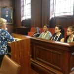 Professor Rothstein speaks with the high school students in the Allen Courtroom. Left to right, they are: Gabrielle Alston, Mahagoni Richardson, Makayla Rankin and Sierra Daniels.