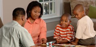 family playing board game