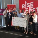 Maggie Galloway (center front, in the tan blazer), CEO of Inscope Medical Solutions, collects her prize from AOL co-founder Steve Case (to Galloway’s left) after winning the Rise of the Rest pitch competition at the UofL Speed Art Museum.