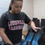 Briana Bonham takes out her vibrating vest which helps loosen built up fluids.