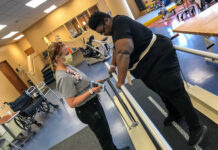 patient undergoes physical therapy in a hospital rehab room