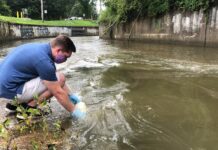 UofL student Sam Kessler using the water testing tool