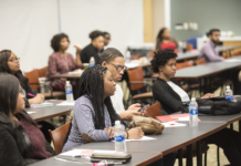 Diverse group of students listen to a presentation.