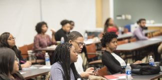 Diverse group of students listen to a presentation.