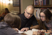 UofL online learning student David Beumer studying at home with family.