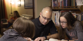 UofL online learning student David Beumer studying at home with family.