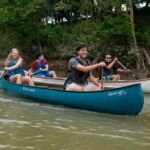 University of Louisville honors students Forest Clevenger (leading the blue canoe) Vinh Pham (leading the white canoe) paddle the Ohio River as part of a class that investigated how river towns can drive tourism and economic development. Photo courtesy John Nation.