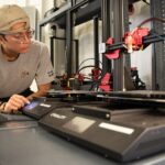 Bioengineering student Jack Roeder uses 3-D printing equipment at University of Louisville’s Additive Manufacturing Institute of Science and Technology