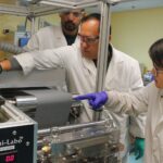 UofL researchers (front to back) Hui Wang, Arjun Thapa and Milinda Bharatha apply a lithium titanate slurry coating to make lithium-ion electrode battery prototypes at UofL’s Conn Center for Renewable Energy Research. The coated anode material is paired with a corresponding cathode sheet to create lithium-ion batteries.