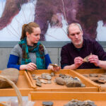 Anthropology faculty and staff examine artifacts