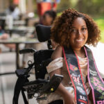 Gabrielle Runyon smiles with her graduation stool wrapped around her neck.