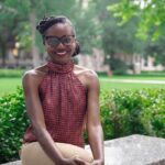 Tabitha Grier-Reed seated on a bench outside.