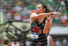 a woman throws the discus in a track and field competition