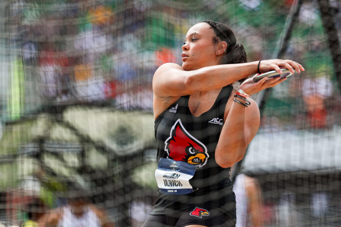 a woman throws the discus in a track and field competition