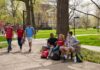 UofL students walking and sitting on campus.