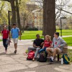 UofL students walking and sitting on campus.