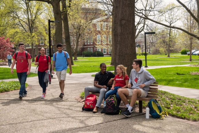 UofL students walking and sitting on campus.