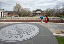 Three students walking past the 3rd Street entrance with Grawemeyer Hall and the School of Law in the background.