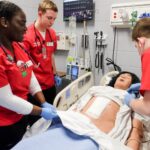 UofL nursing students work in the simulation lab.