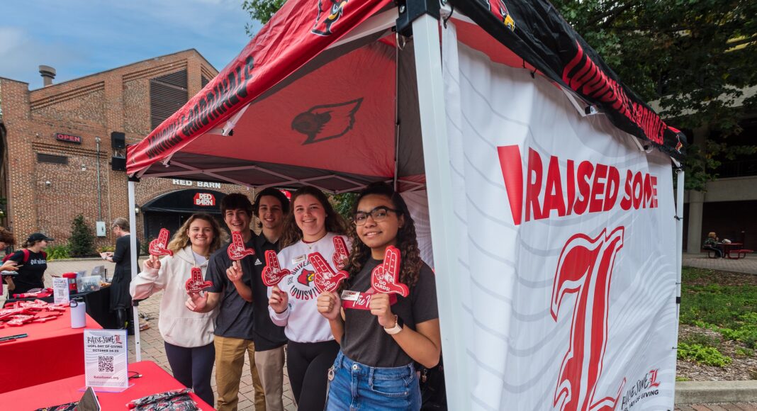 Group of students standing under a tent.