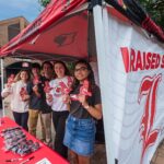 Group of students standing under a tent.