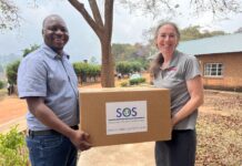 Rochelle Holm, UofL associate professor in the Christina Lee Brown Envirome Institute, and Petros Chigwechokha, head of the Department of Biological Sciences at Malawi University of Science and Technology, received a shipment of medical and research supplies thanks to SOS International in Louisville.