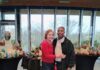 A photo of Tonya Johnson and her partner standing in front of her pottery