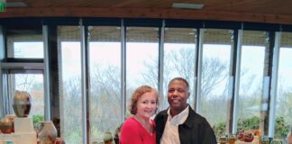 A photo of Tonya Johnson and her partner standing in front of her pottery