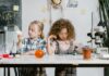 Two children exploring science at a table.