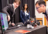 Computer Science and Engineering students Dylan Nicholson and Ruthmika Chenna explain their team's capstone project to Dr. Sam Park at the Engineering Design and Innovation Showcase.