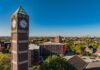 High angle shot of the Student Activities Center clock tower with downtown Louisville in the distance