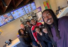 Ethan McNary at a Taco Bell restaurant with team members